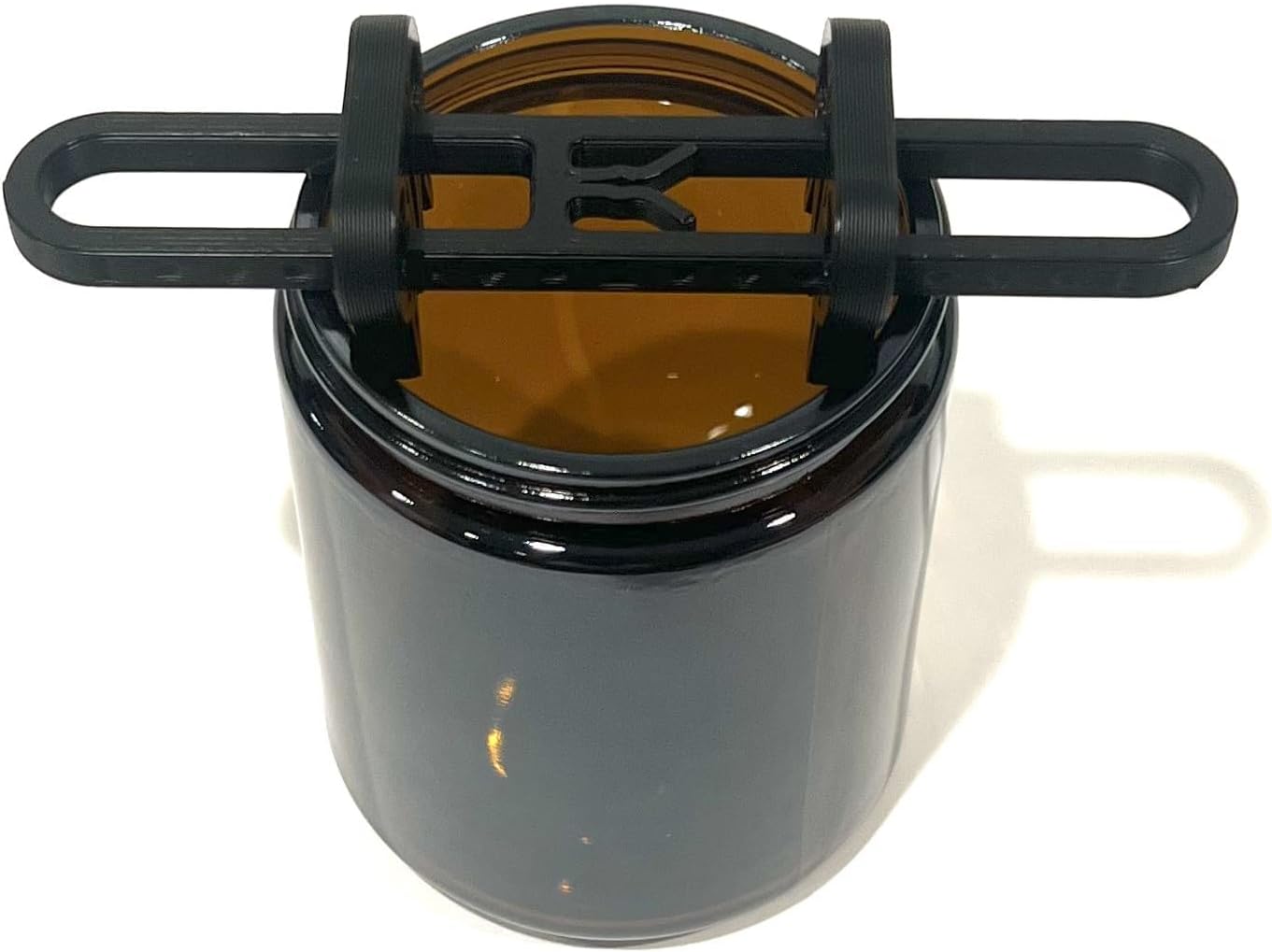 Wick Centering Tool - top-down view on amber jar